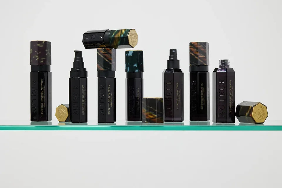 Auteur skincare arranged on a glass shelf in a stop-motion composition