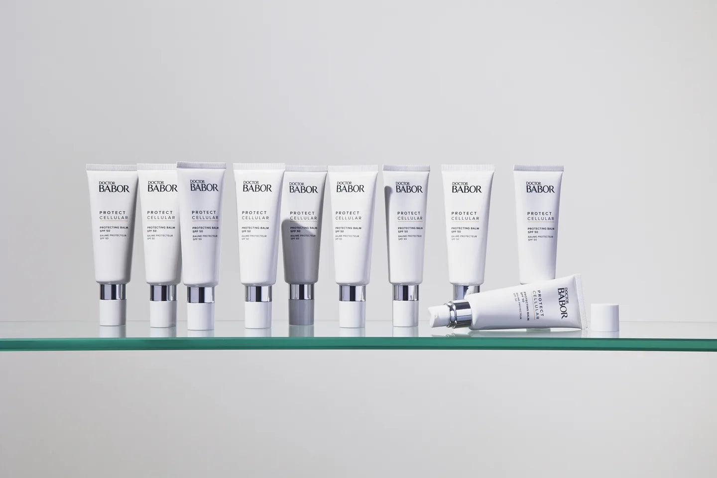 Dr Babor Protecting Balm tubes arranged on a glass shelf