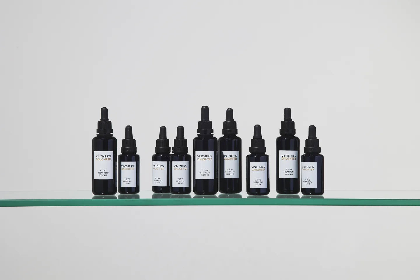 Vintner's Daughter Active Treatment Essence and Active Botanical Serum arranged on a glass shelf